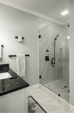 A photo of a bathroom with a glass door leading to the shower
